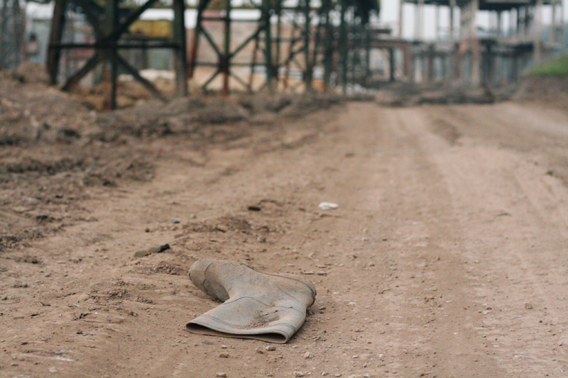 Wellington boot abandoned on derelict industrial site.<br />ROMANIA, Resita | 2008